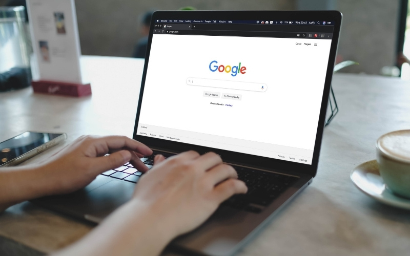 Person using Google on laptop in relation to Google Core Updates 2025 December